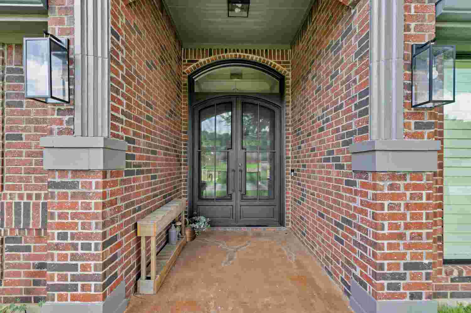 Traditional arched steel double door with clear glass