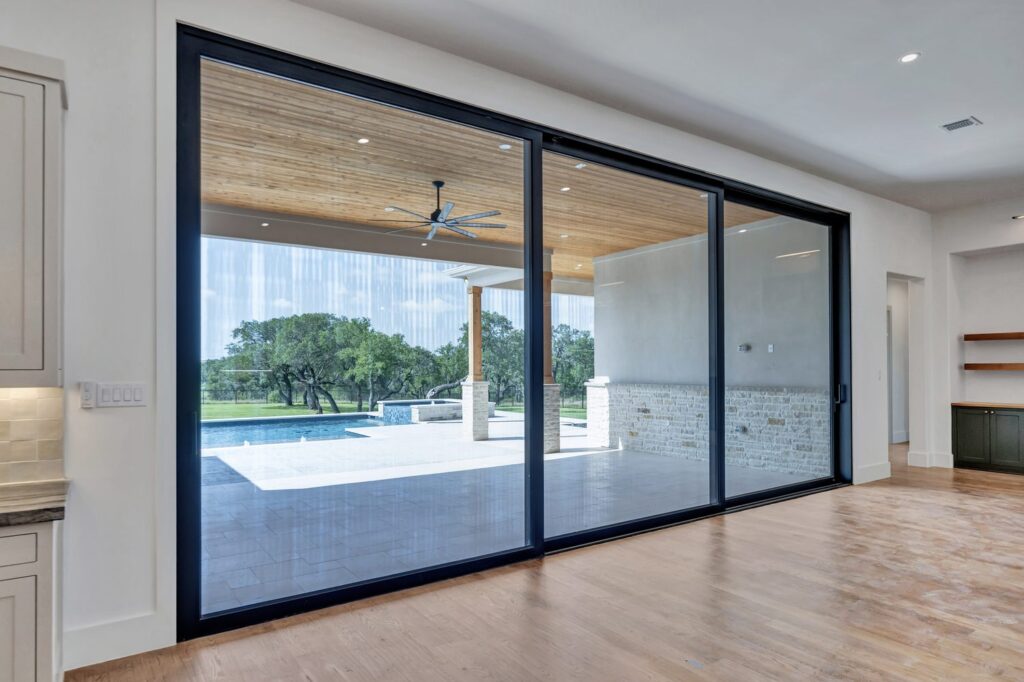 Modern black framed sliding glass door installation