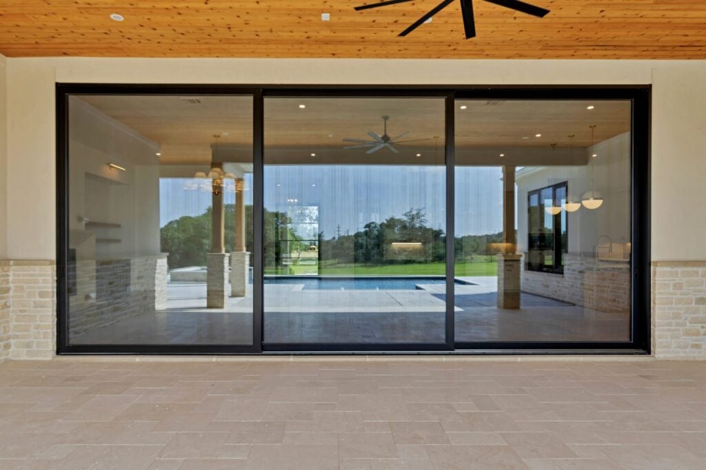 Black framed sliding glass door at an outdoor entryway