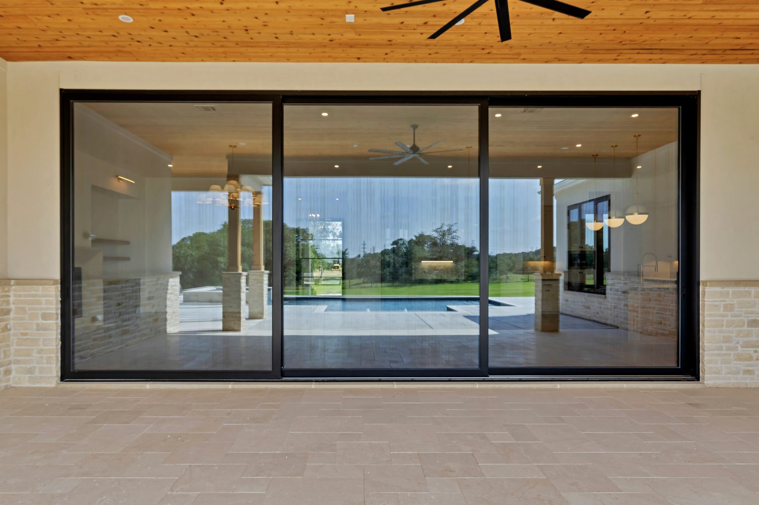 Black framed sliding glass door at an outdoor entryway