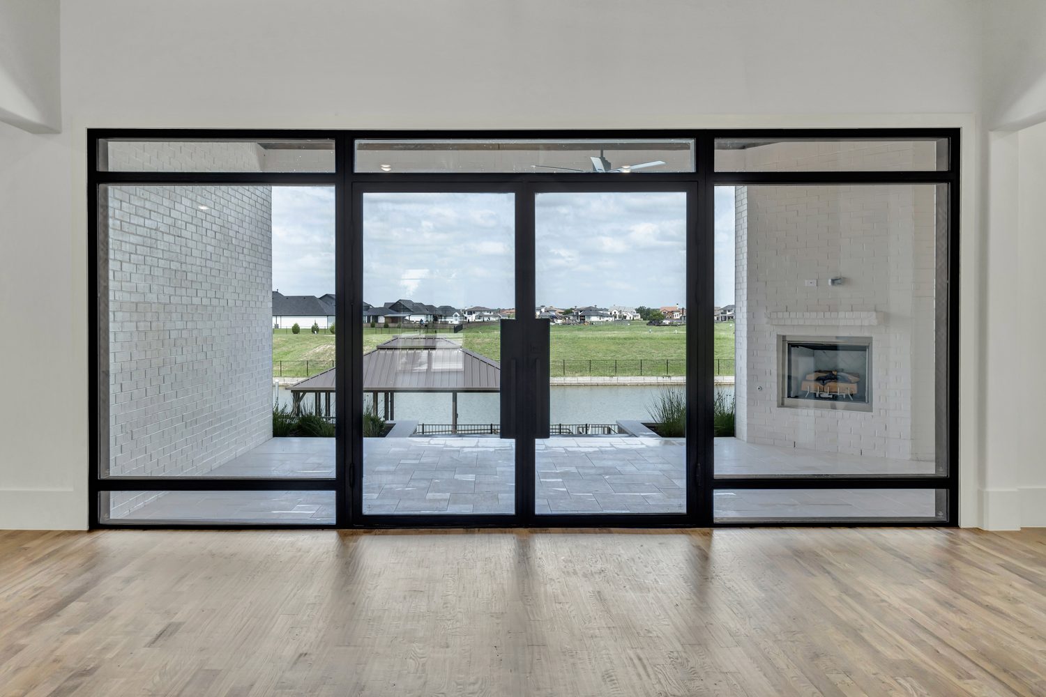 Black framed sliding glass door with patio view