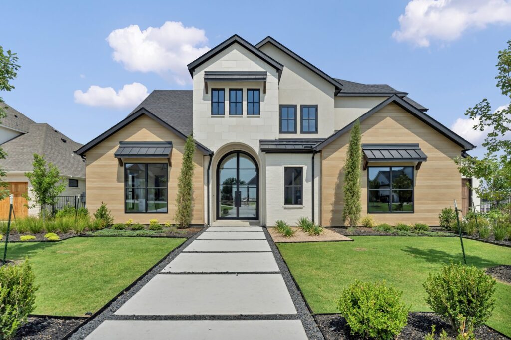 Custom steel arched entry door on a modern house exterior from Love That Door