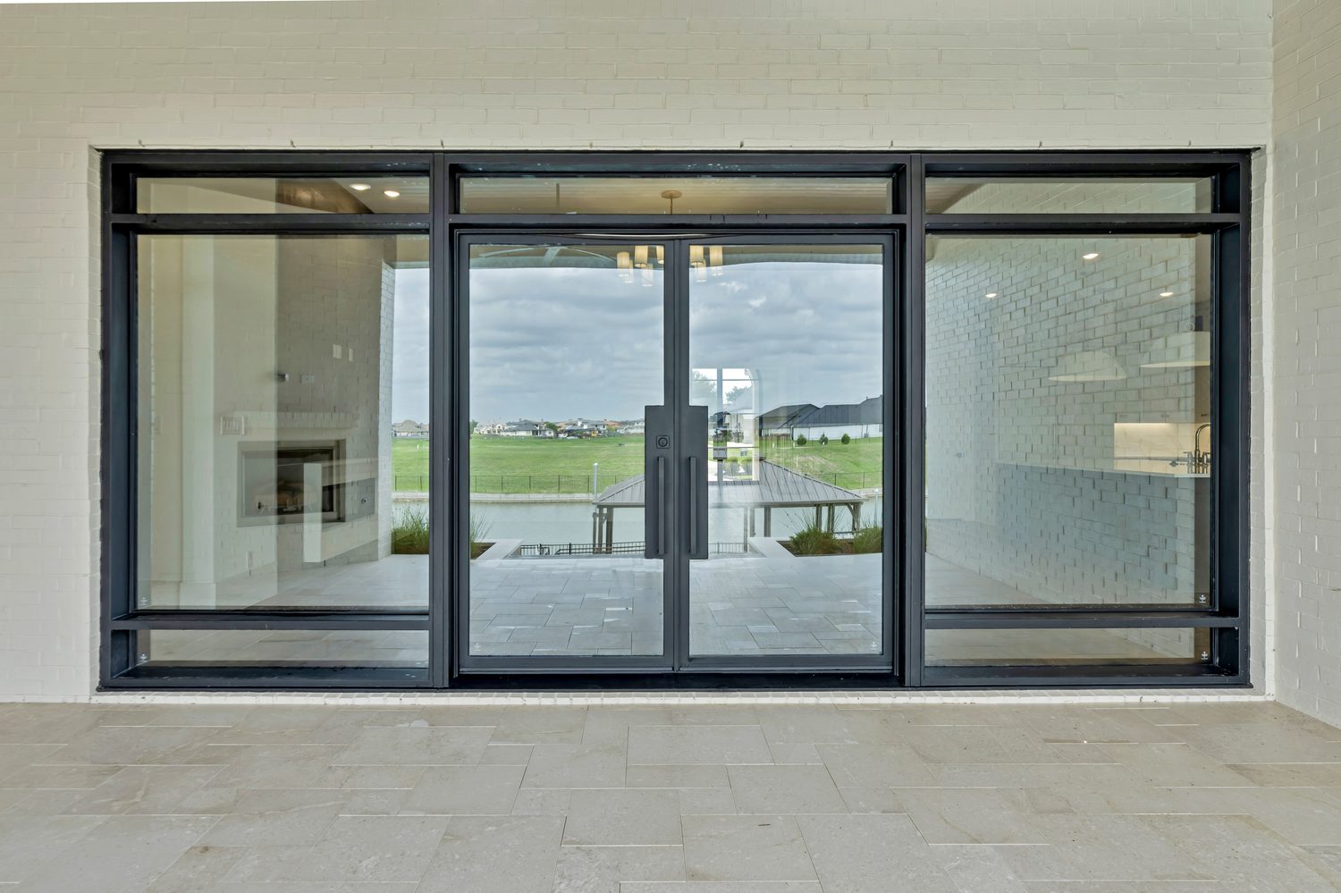 Custom steel entry door with black frame and glass panels from Love That Door