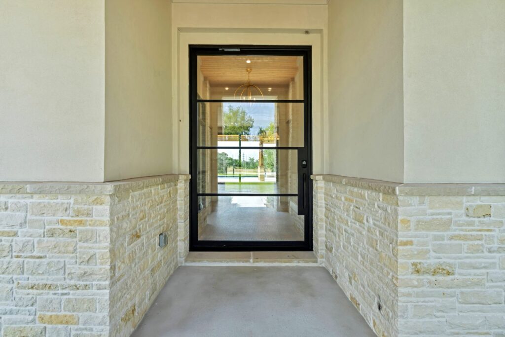 Custom steel entry door with black frame and clear glass from Love That Door custom door maker