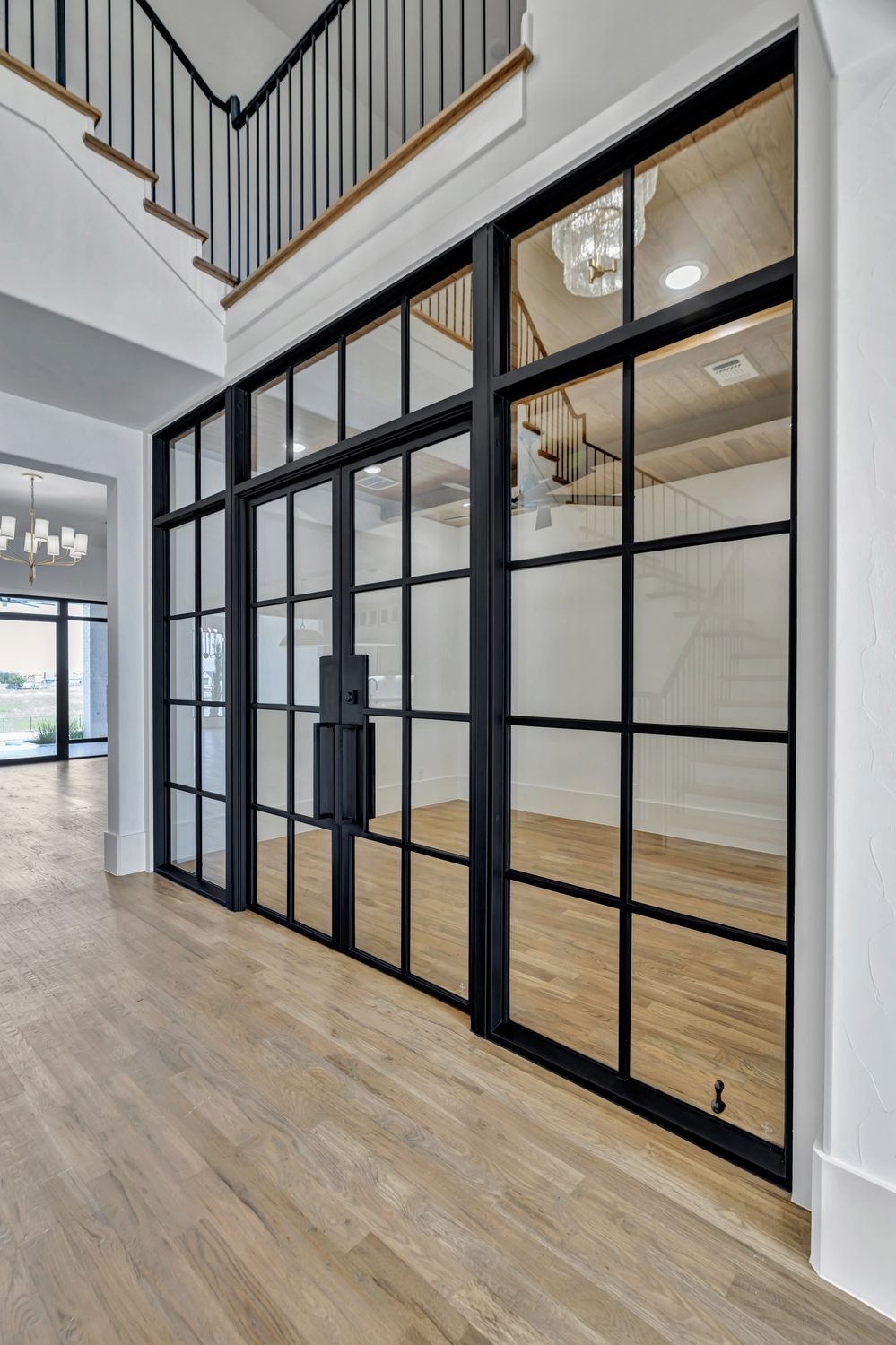 Custom steel entry door with black grid glass panes from Love That Door