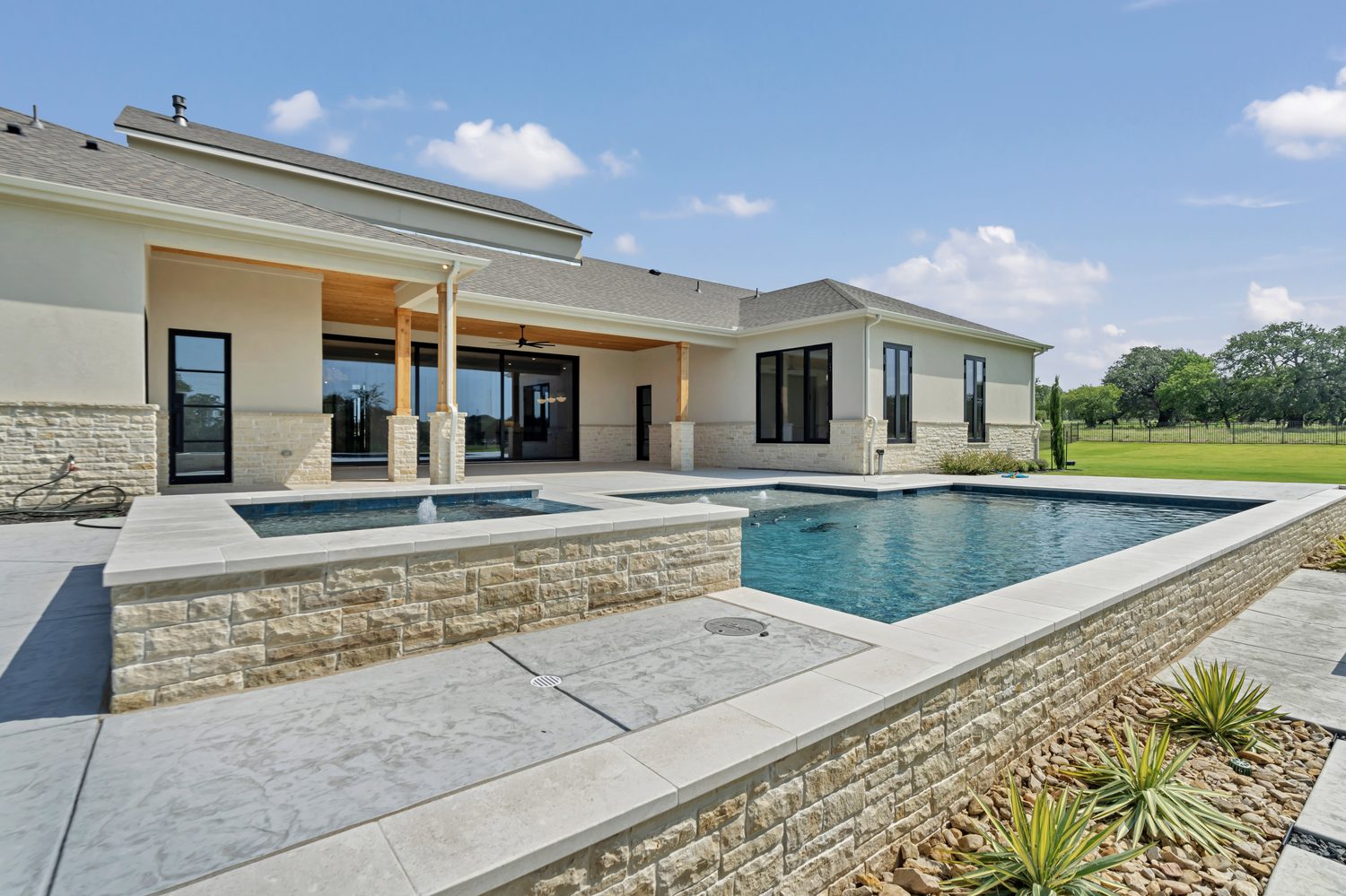 Modern backyard with swimming pool patio and landscaping