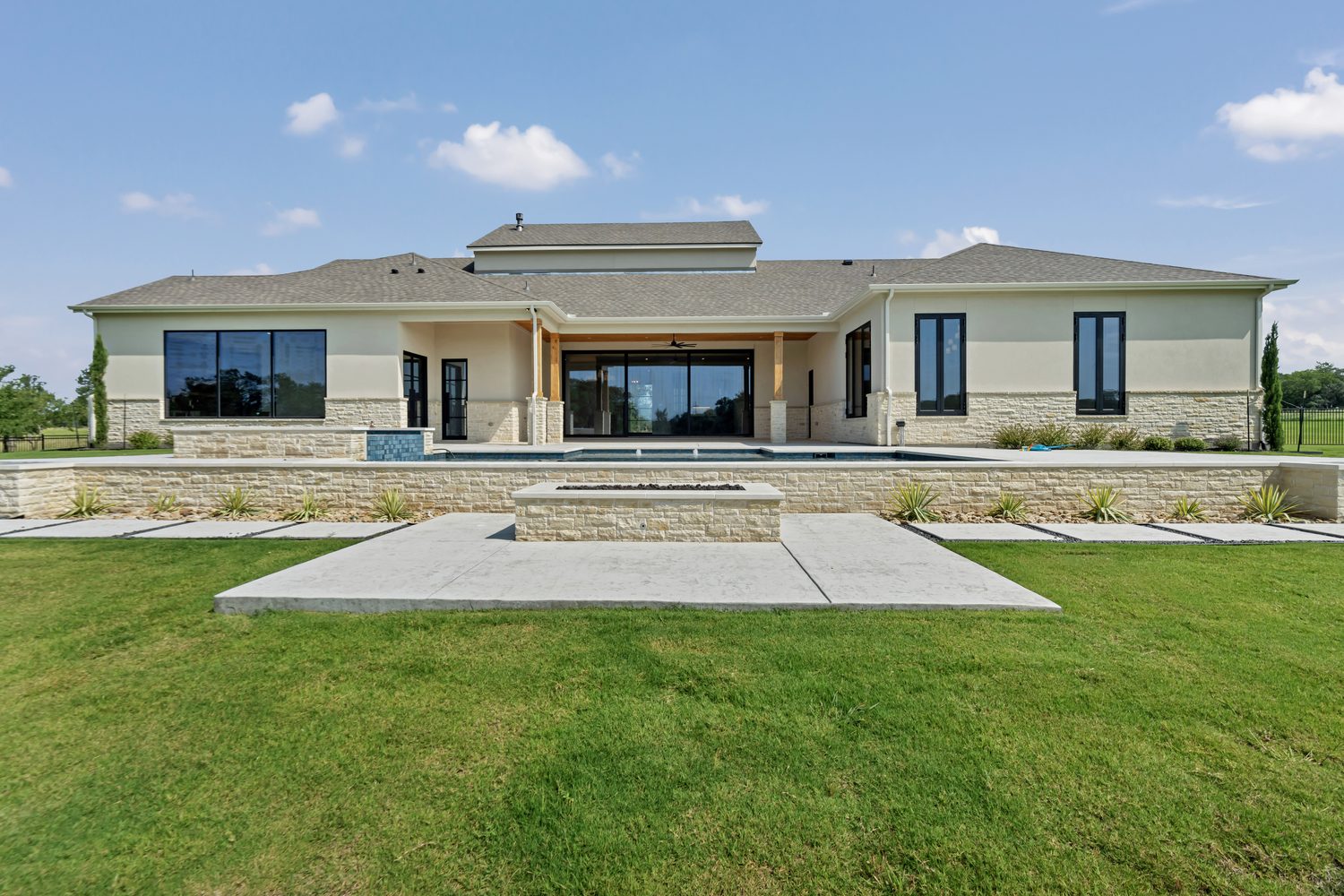 Modern house exterior with large windows and stone facade
