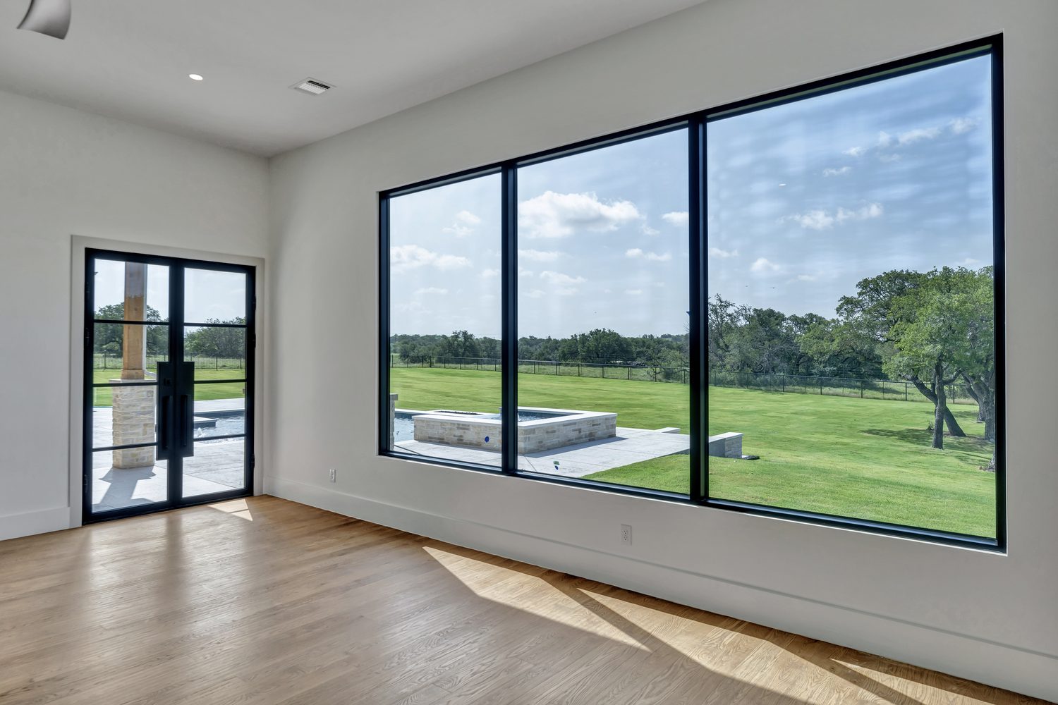 Modern interior featuring a black entry door with glass panes
