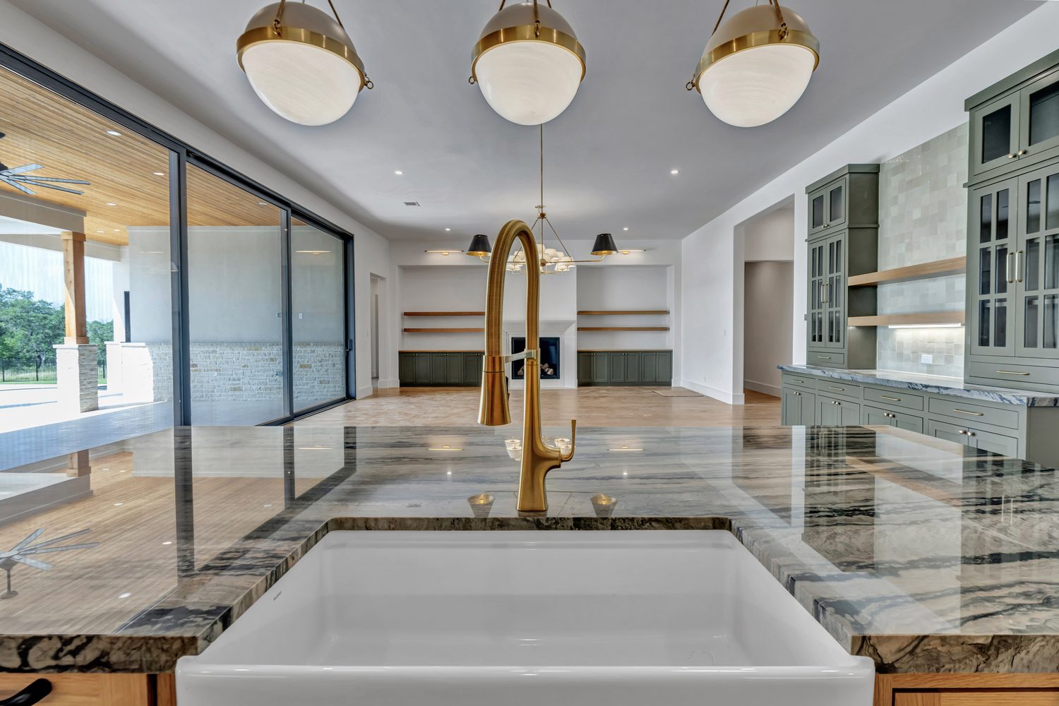Modern kitchen with granite island and glass doors