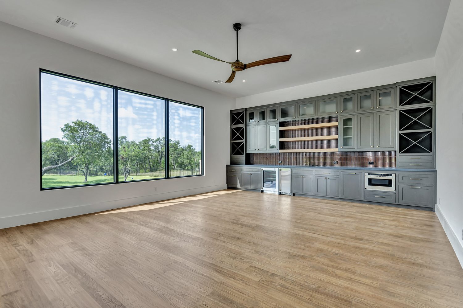 Modern kitchen with large windows in a custom luxury home
