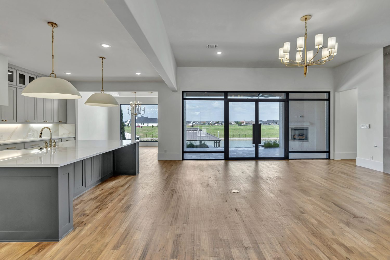 Modern open plan living and kitchen with large glass doors