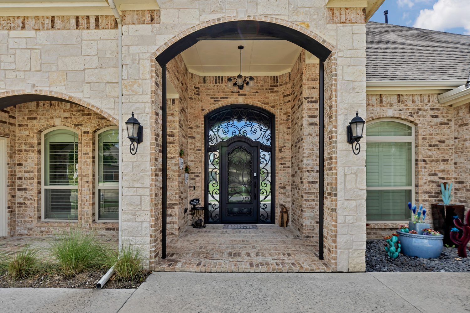 Traditional black iron single door arched with scrollwork from Love That Door