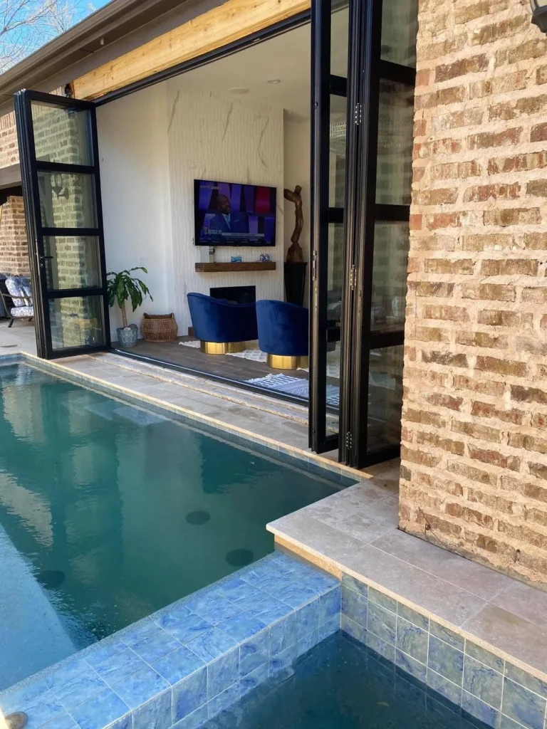 Aluminum four panel bifold door open to pool