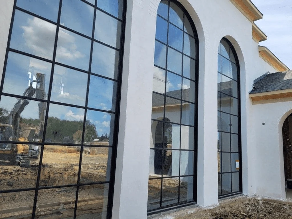 Black aluminum arched windows with mullions