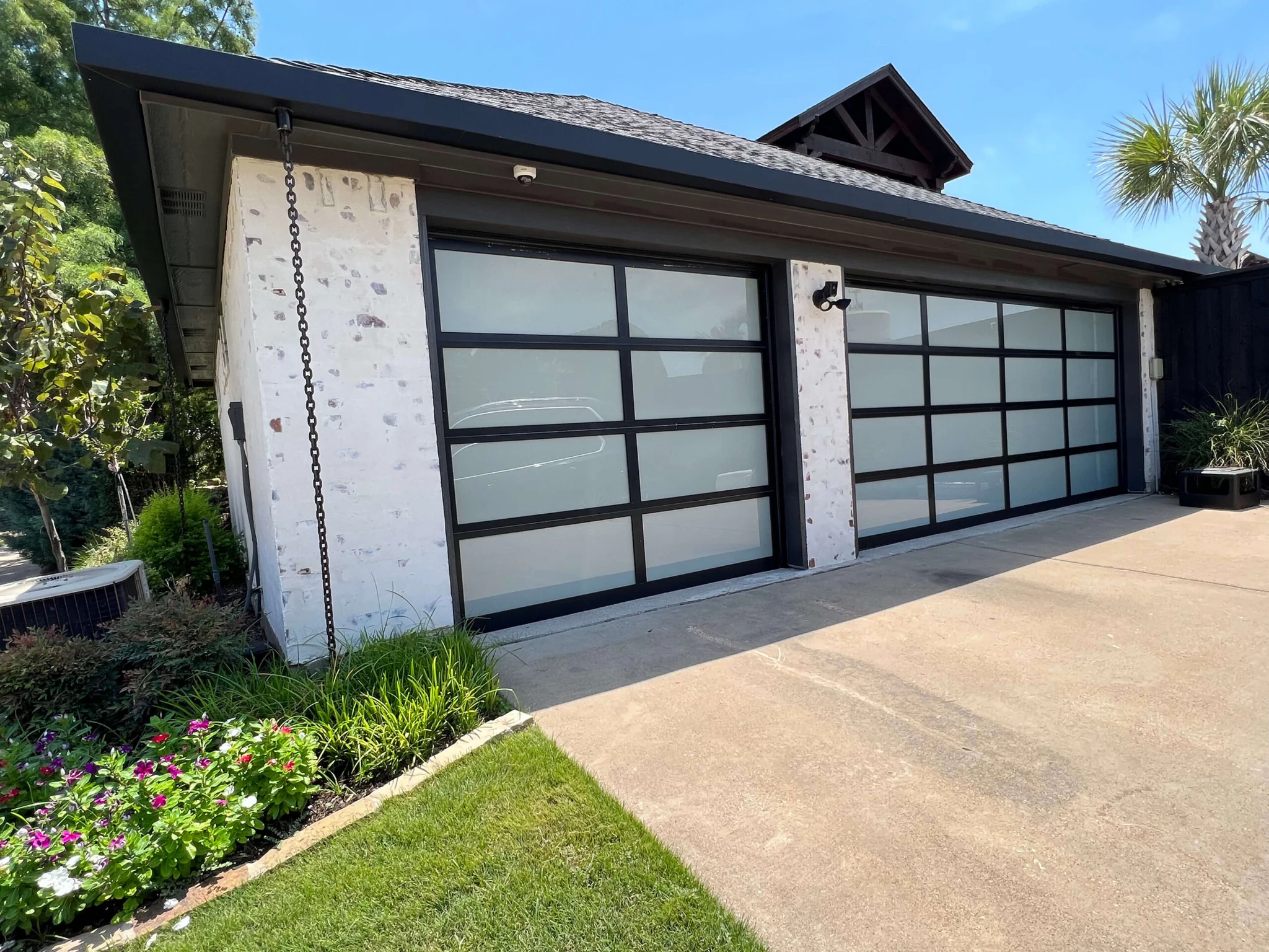 Modern double garage doors with frosted glass grid panels