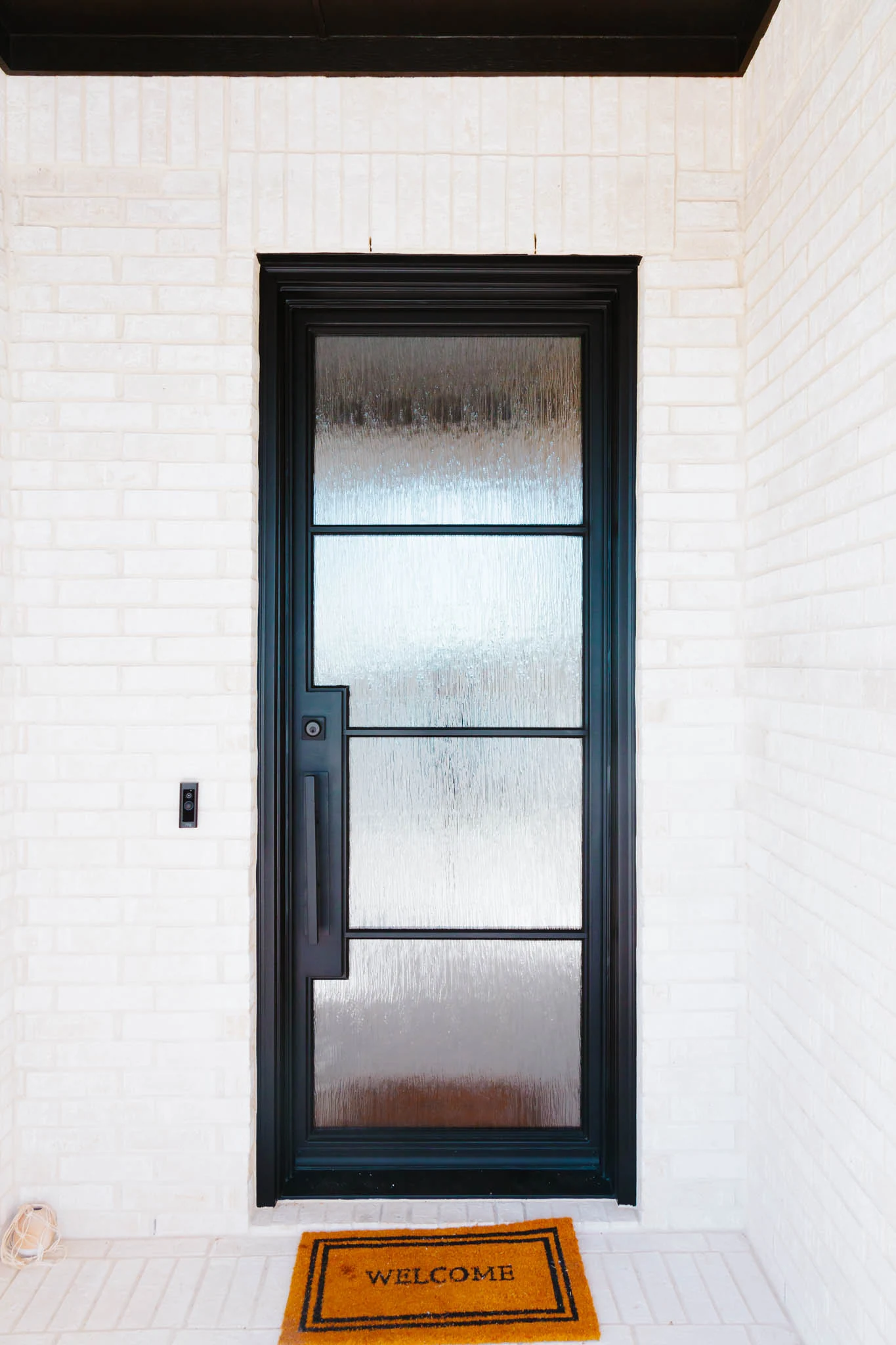 Single steel glass door with black frame divided into three sections