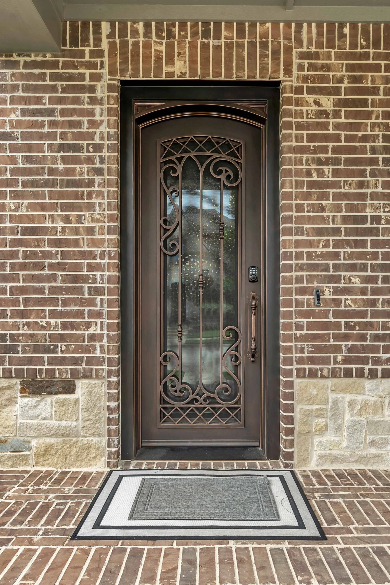Dark bronze single wrought iron entry door with glass panel from Love That Door